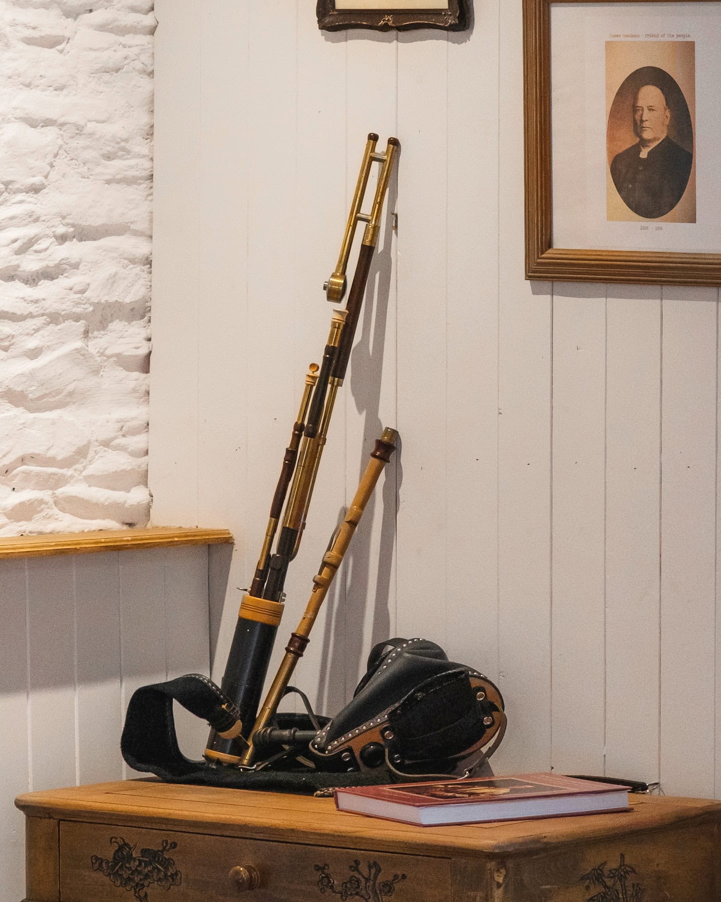 Display of traditional Uilleann pipes inside Pipers Cottage, honouring Canon James Goodman’s musical legacy and the cottage’s rich cultural history.